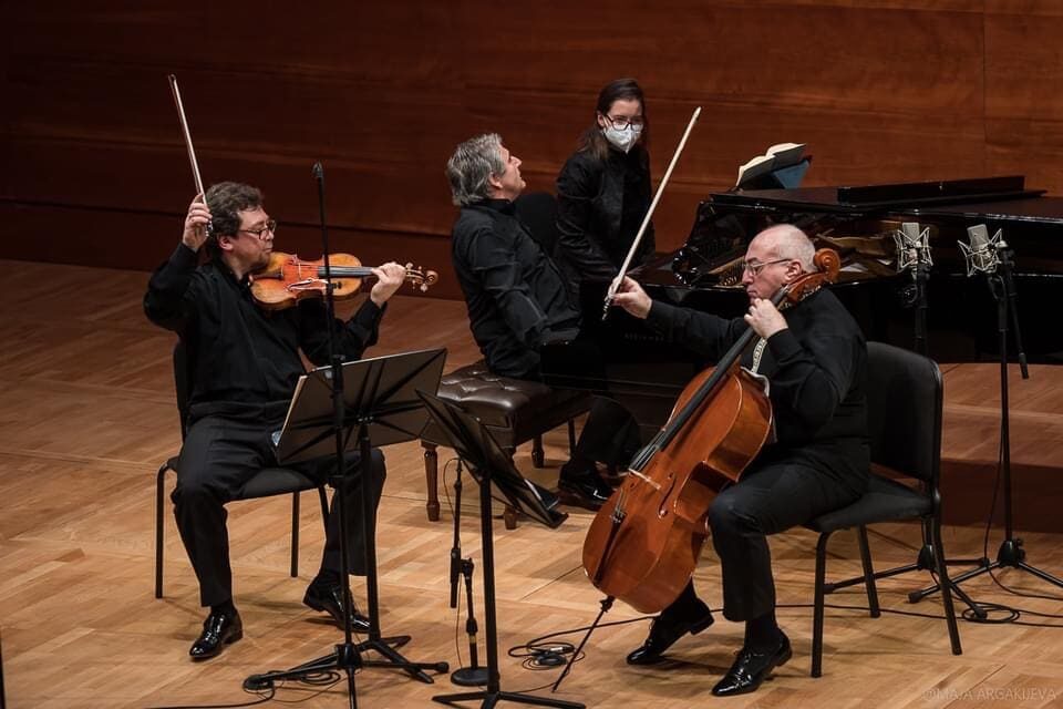 Alexander Kaganovsky playing in a chamber concert with a violinist and a pianist